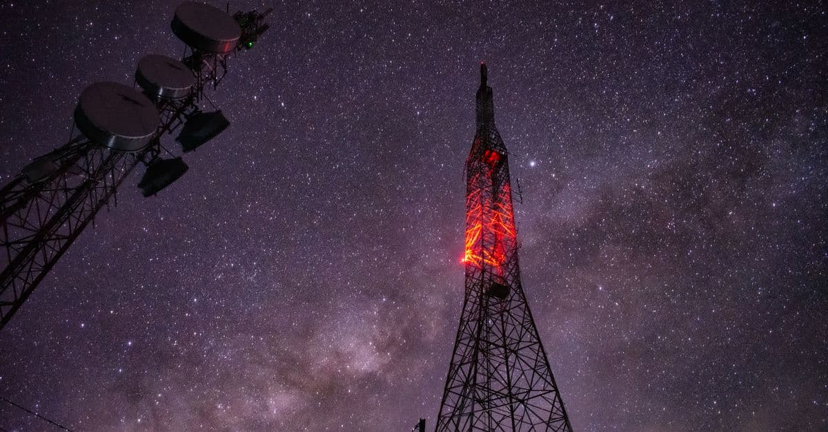 Stunning capture of a communication tower under a star-filled night sky.