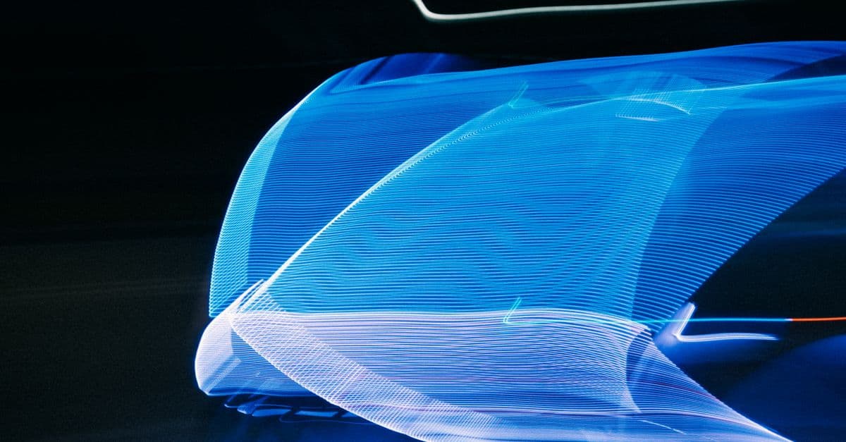 Abstract motion blur of blue light streaks on a black background creating a futuristic visual effect.