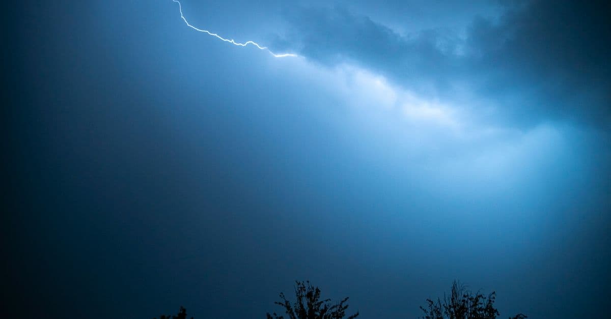 Captivating image of a lightning strike cutting through a dark, stormy sky.