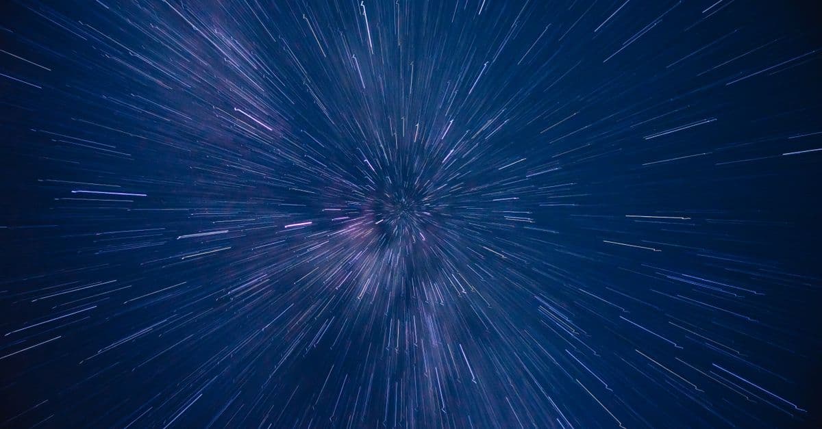 Dynamic star trails creating a dazzling starburst effect in the night sky, captured with long exposure.