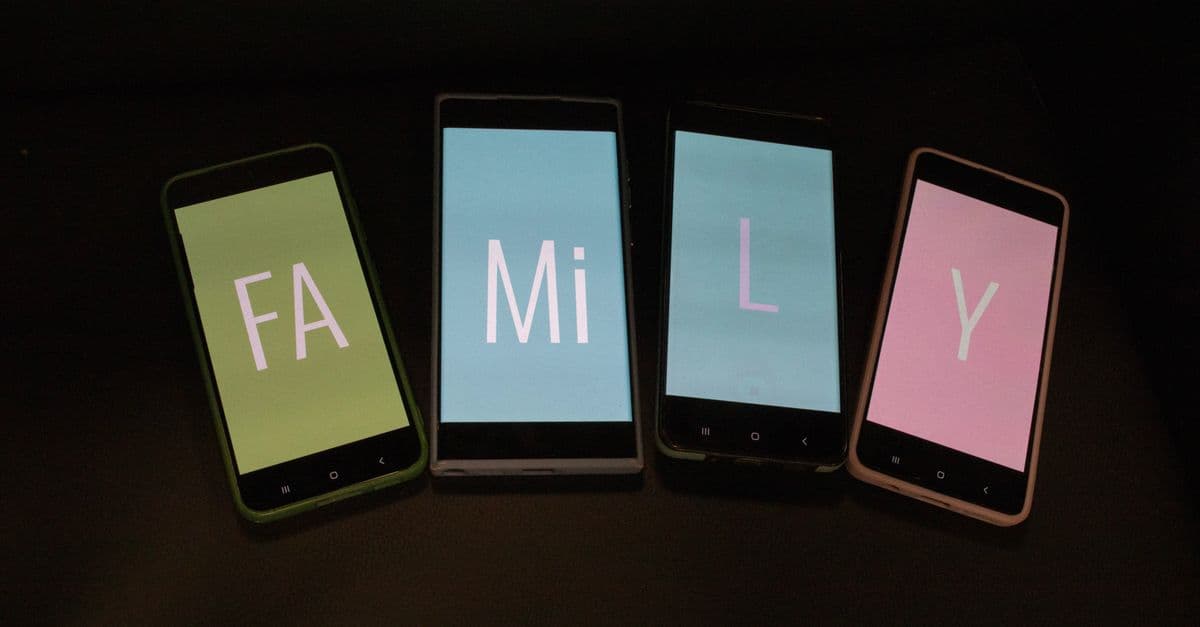 Four smartphones with colored screens spell 'Family' with split letters on a dark background.