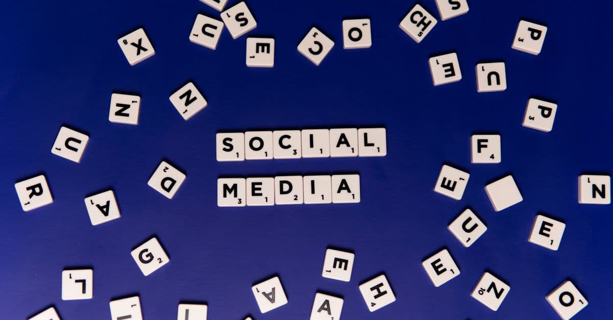 Scrabble tiles spelling 'Social Media' on a blue background, ideal for digital marketing themes.