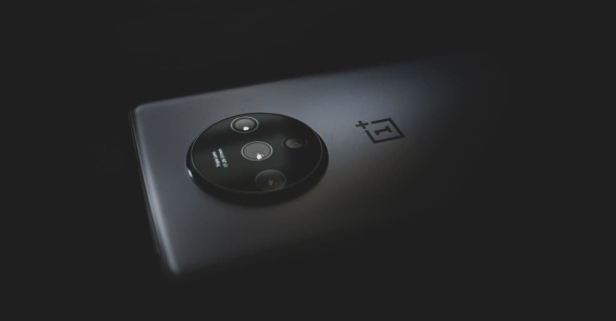 Detailed close-up of a modern smartphone camera against a dark background.