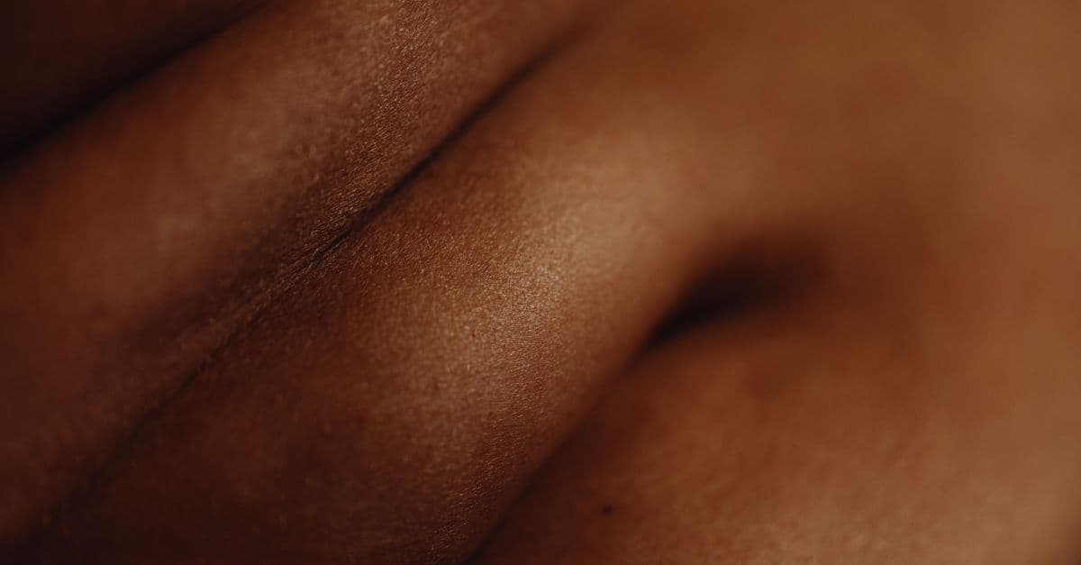 An artistic close-up photograph showcasing the natural folds and texture of human skin under soft lighting.