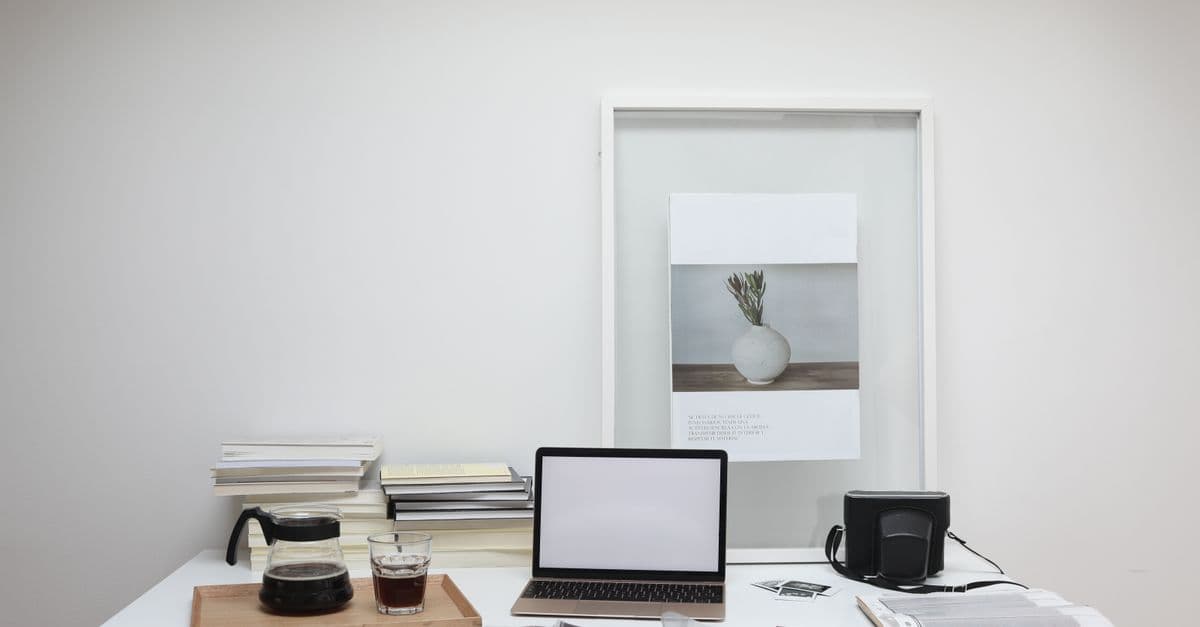 Interior of contemporary workspace with laptop near coffee and roll film on table
