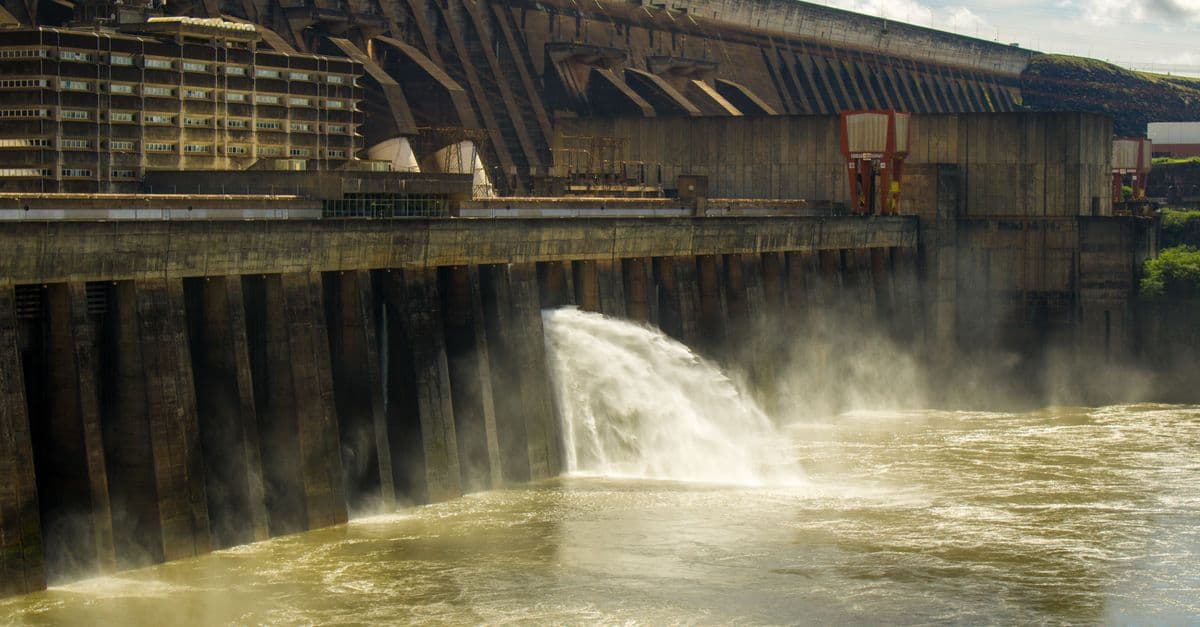 Scenic view of Itaipu Dam releasing water into the Paraná River, highlighting engineering marvel.
