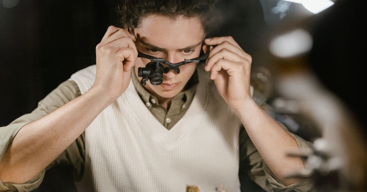 Skilled watchmaker at work with a loupe in a repair shop, showcasing precision and expertise.