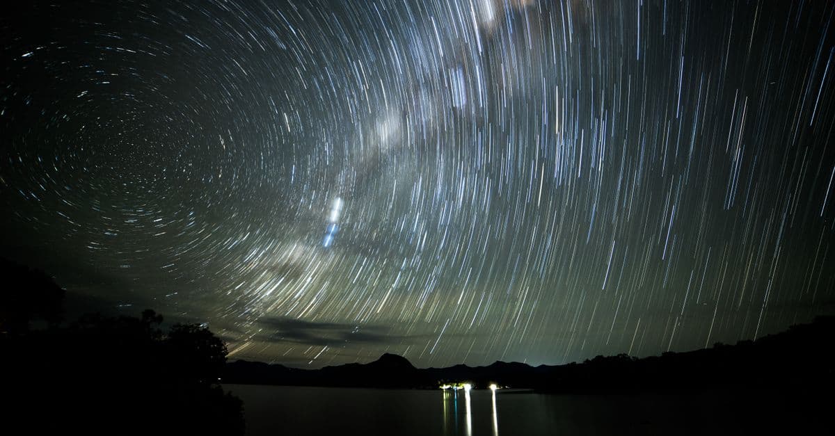 Captivating long exposure of star trails forming circular patterns over Lake Moogerah, Australia.