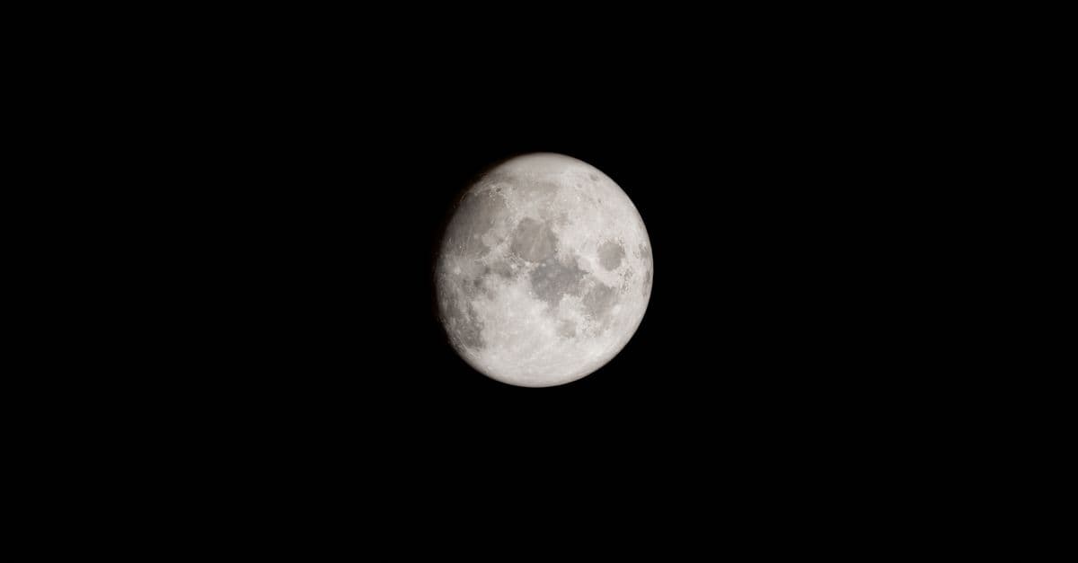 A detailed capture of the full moon set against a stark black sky, ideal for astronomy enthusiasts.