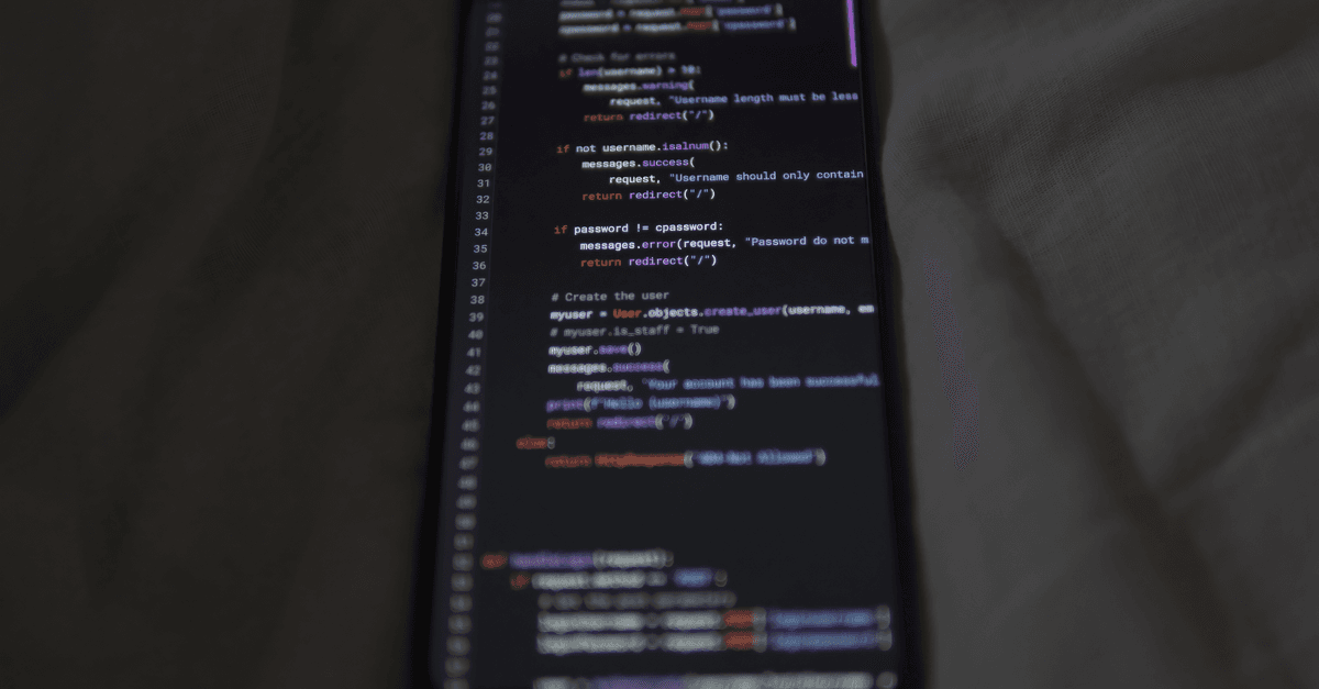 Close-up of a smartphone showing Python code on the display, showcasing coding and technology.