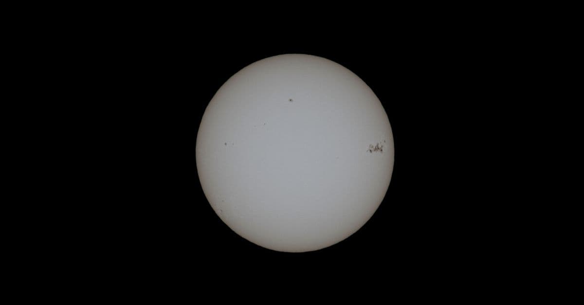 Close-up image of the sun with visible sunspots on a black background.