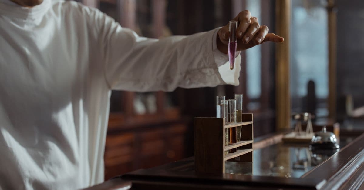Pharmacist in classic lab holding test tube with liquid, vintage style.