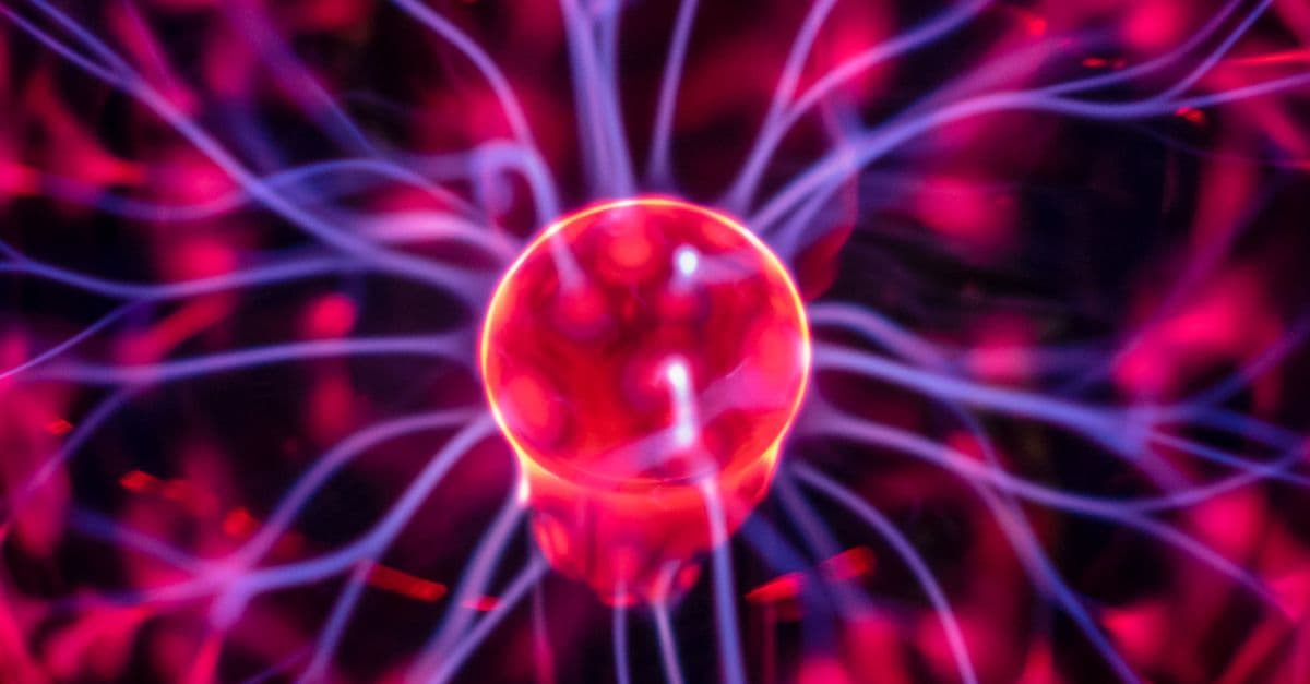Close-up of a vibrant plasma globe with electric streams, perfect for science or energy concepts.
