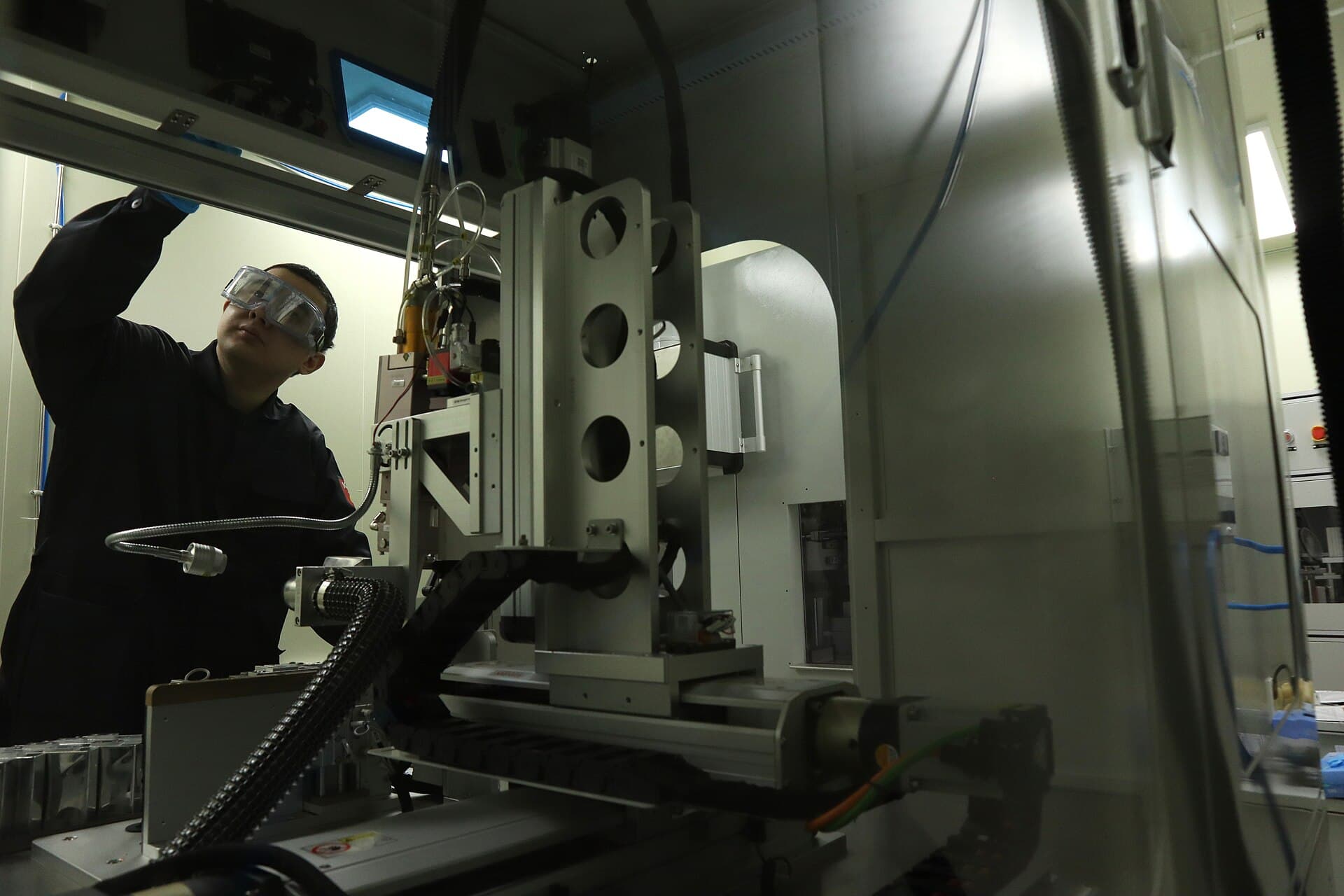 A battery researcher operating a pilot line for energy-storage technology.