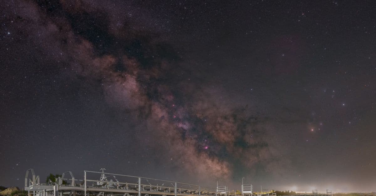 Captivating night view of the Milky Way galaxy above metal structures located in Legrad, Croatia.