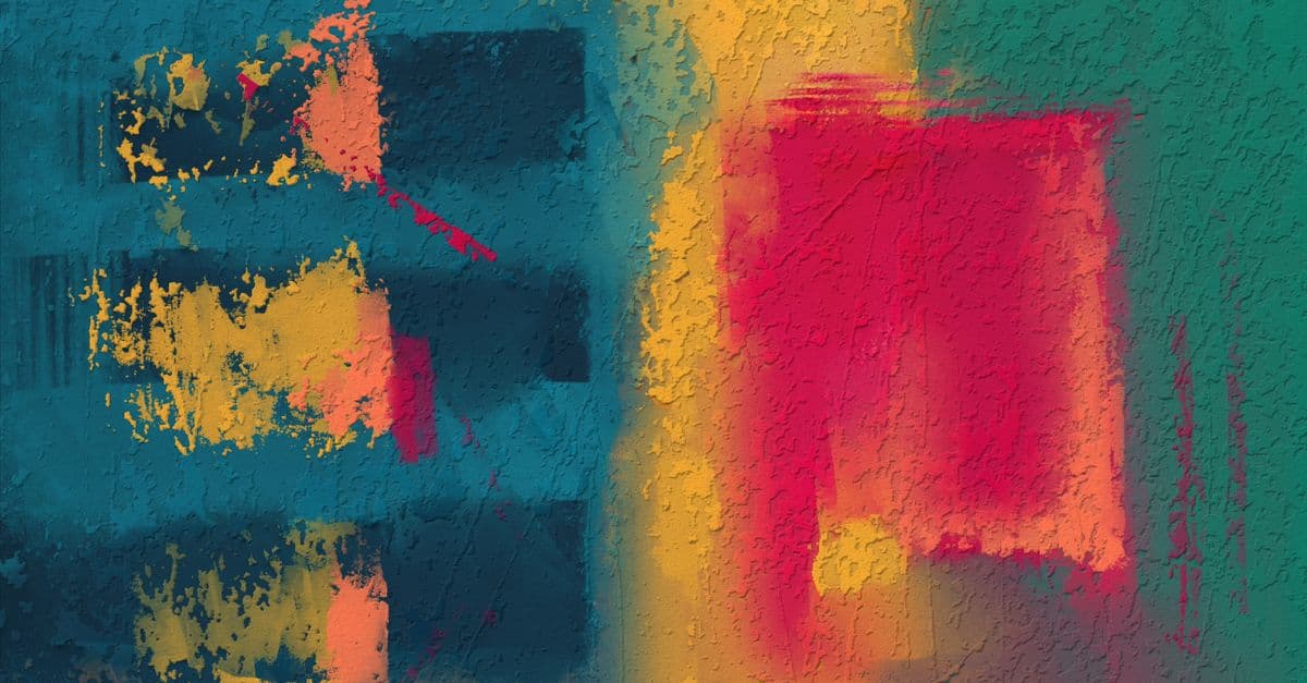 Vibrant abstract mural showcasing textured colors on a wall, a bold street art piece.