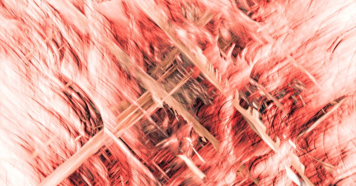 Swirling red and beige textures creating a dynamic abstract art piece full of motion.