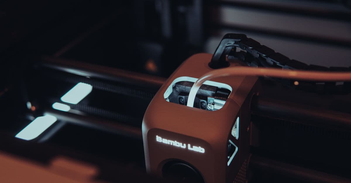 Detailed view of a 3D printer mechanism in a dark setting, highlighting technology.
