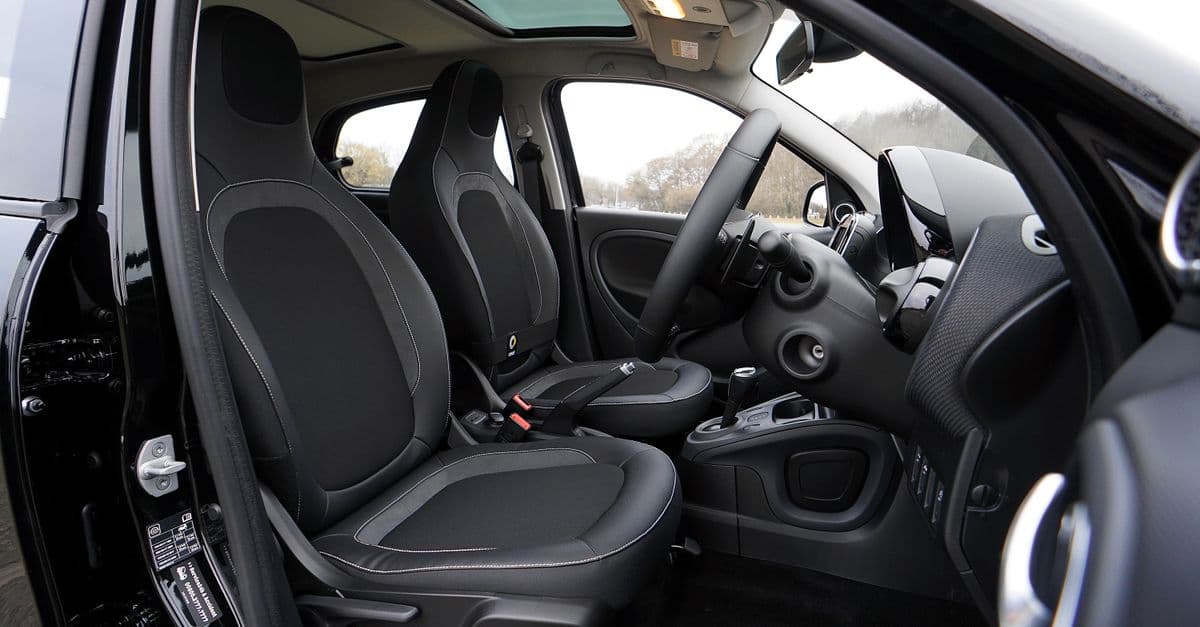 Explore a modern car's interior featuring black leather seats and advanced technology.