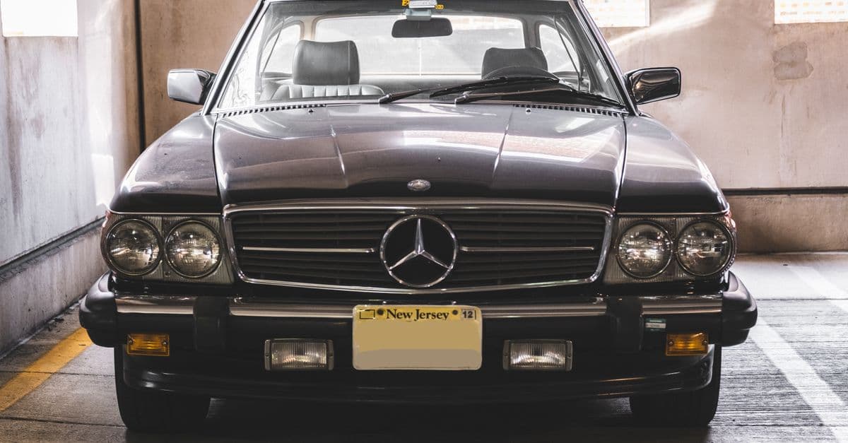 Classic Mercedes-Benz vehicle parked in an indoor lot with retro design and chrome details.