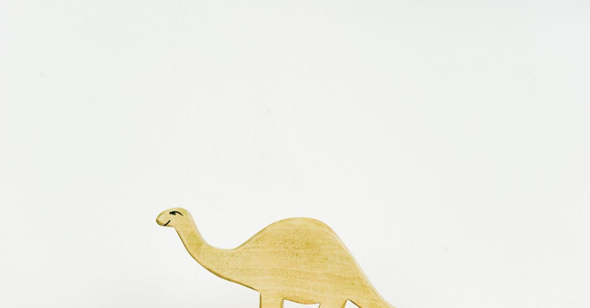 Simple wooden dinosaur figurine on display with a clean background, showcasing minimalist design.