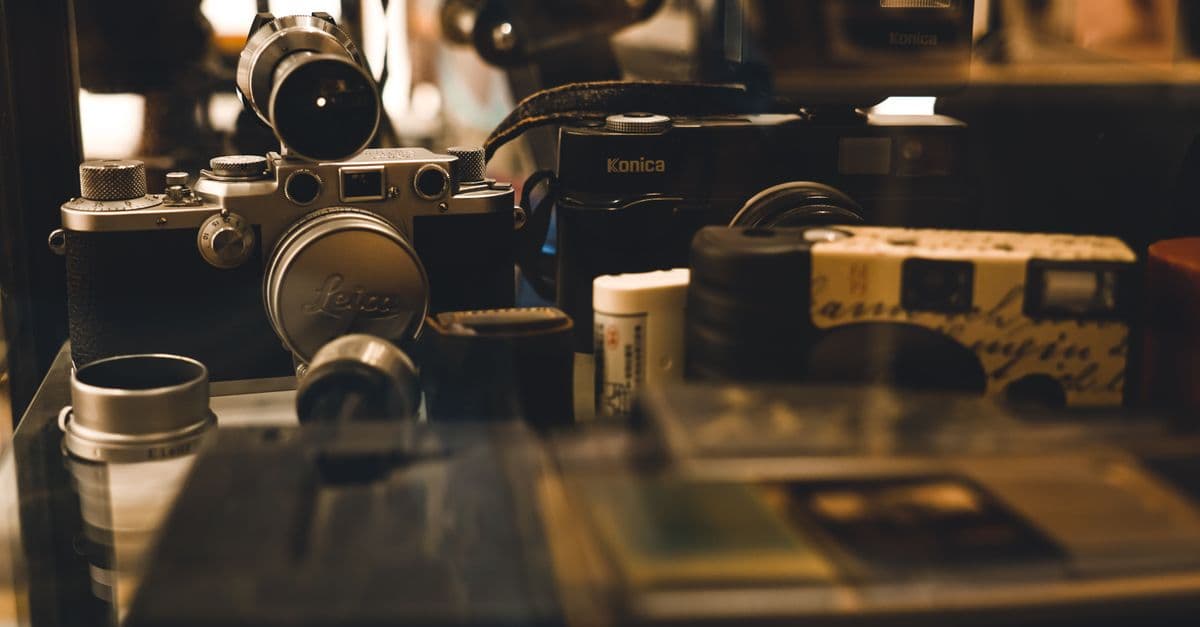 A collection of vintage cameras and photography equipment showcased in a display, highlighting retro aesthetics.