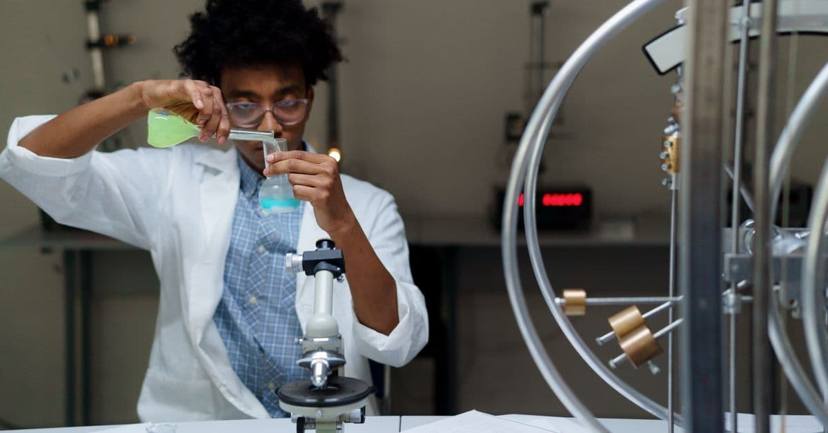 A scientist experiments with chemicals in a laboratory, making scientific discoveries.