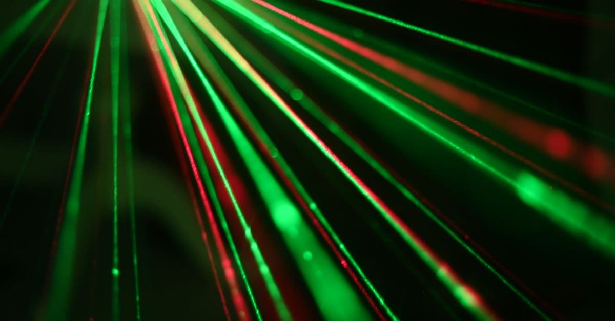 Vibrant display of red and green laser light beams creating dynamic patterns.
