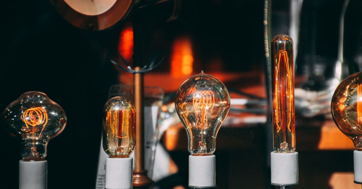 A collection of vintage Edison light bulbs glowing warmly, showcasing intricate filaments.