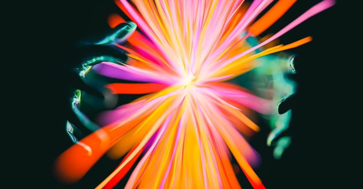 Abstract display of colorful lights and hands creating a vibrant, magical effect.