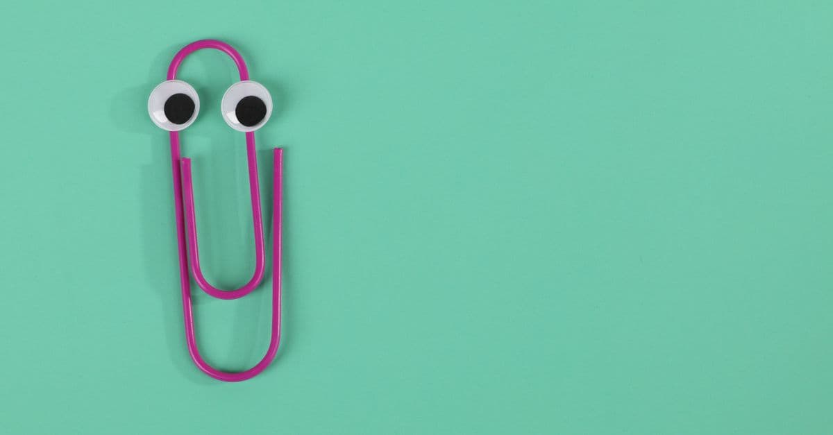 A playful pink paperclip with googly eyes on a green pastel background offers fun visual appeal.