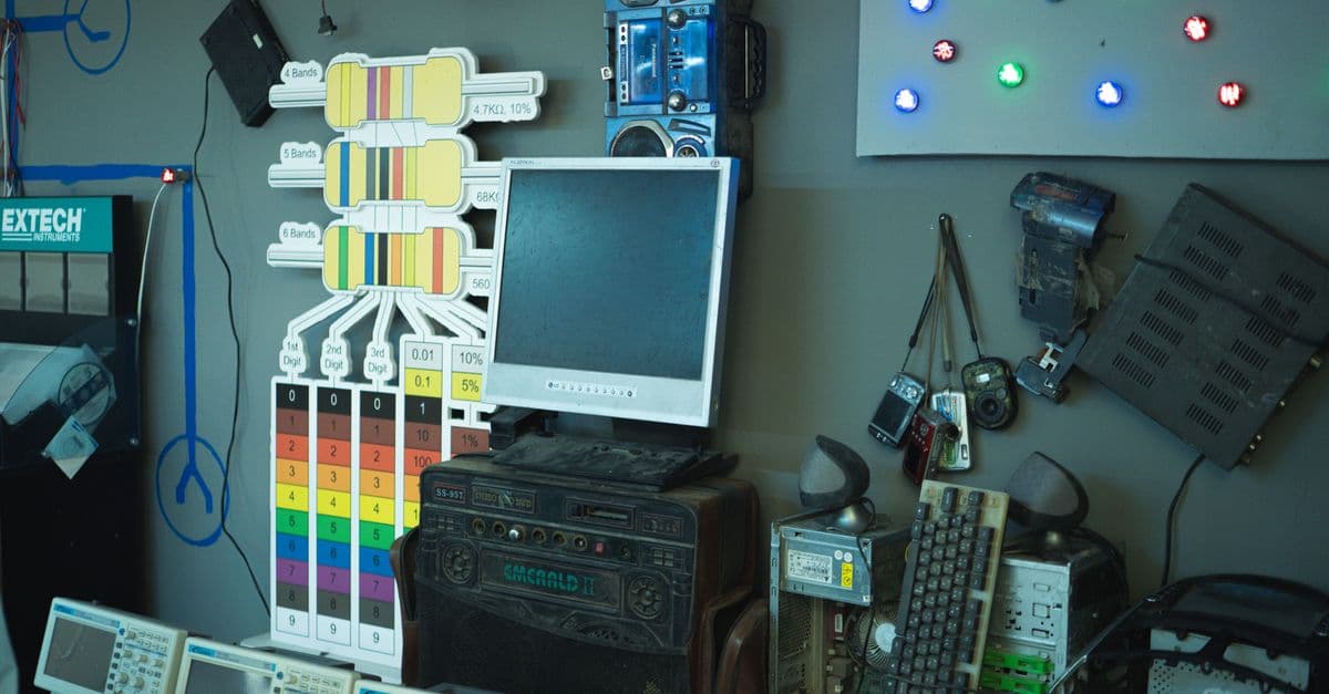 A cluttered wall of vintage electronics and gadgets, showcasing retro technology in a creative setup.