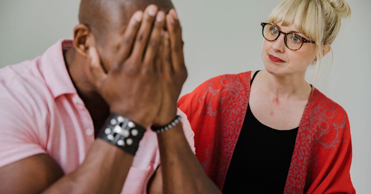 A supportive counseling session between a caring mentor and an emotional individual.