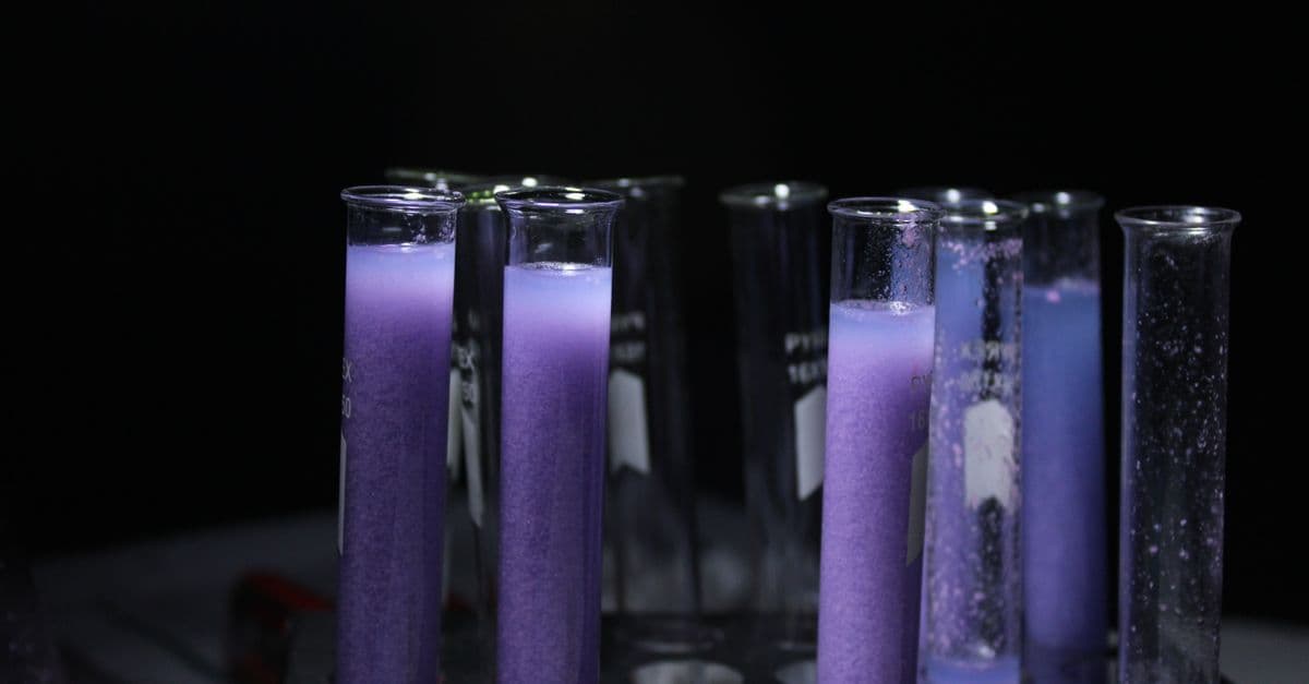 Close-up of purple liquid in test tubes against a black background, ideal for scientific and educational content.