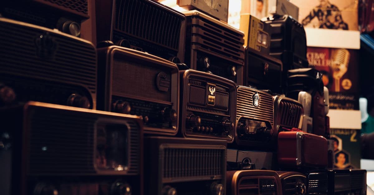 A nostalgic collection of vintage radios captured in warm ambient lighting.