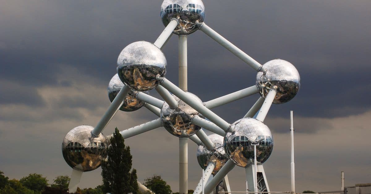The Atomium in Brussels, Belgium, showcasing its unique steel spheres against a dramatic sky.