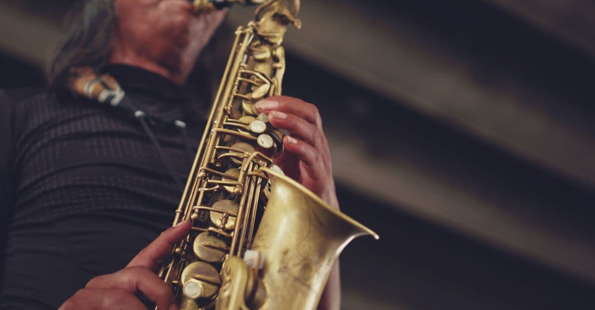Close-up of a jazz musician performing with a saxophone, showcasing musical artistry.