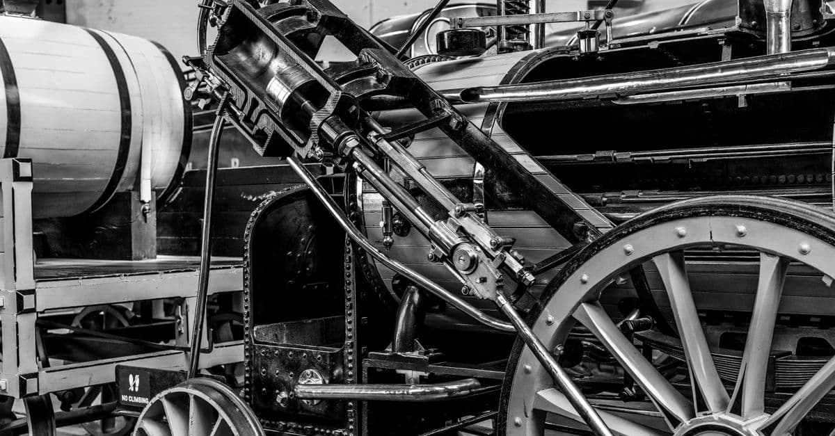 Classic black and white photo of a vintage steam engine showcasing its intricate machinery.