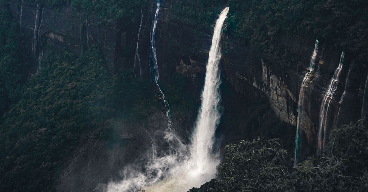 A breathtaking view of waterfalls cascading in the lush forests of Shillong, India.