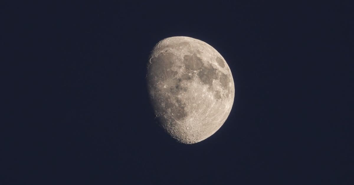 A detailed capture of the waning gibbous moon against a dark and clear night sky.