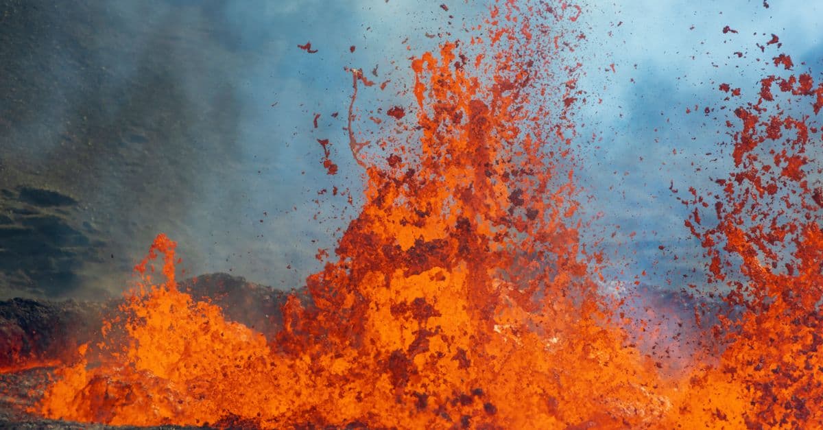 Close-up of vibrant orange lava erupting from a volcano, capturing the intensity and power of nature.
