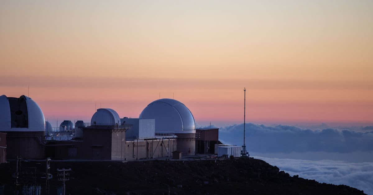 Observatory domes against a vibrant sunset sky, capturing astronomical beauty.