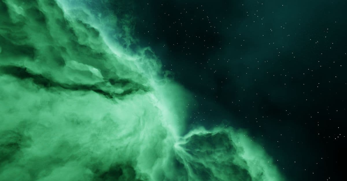 Captivating view of an abstract green nebula set against a starry night sky.