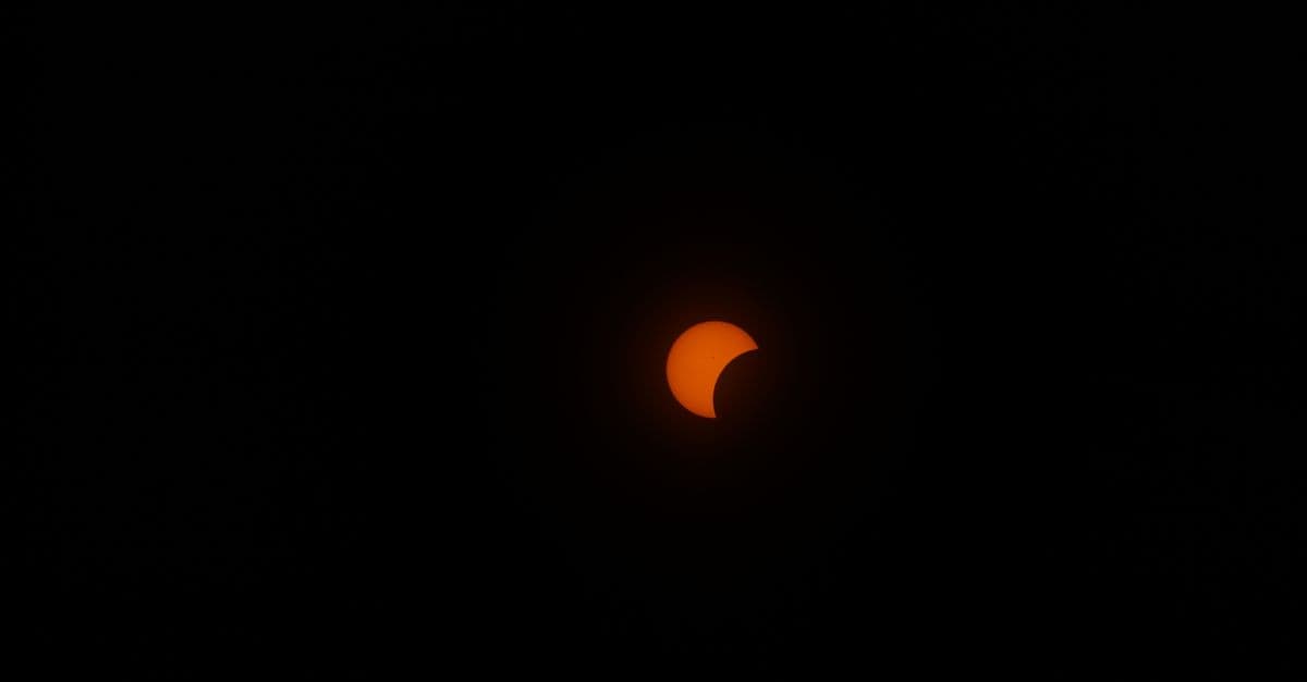 A mesmerizing view of a partial solar eclipse set against a dark night sky, highlighting the celestial event.
