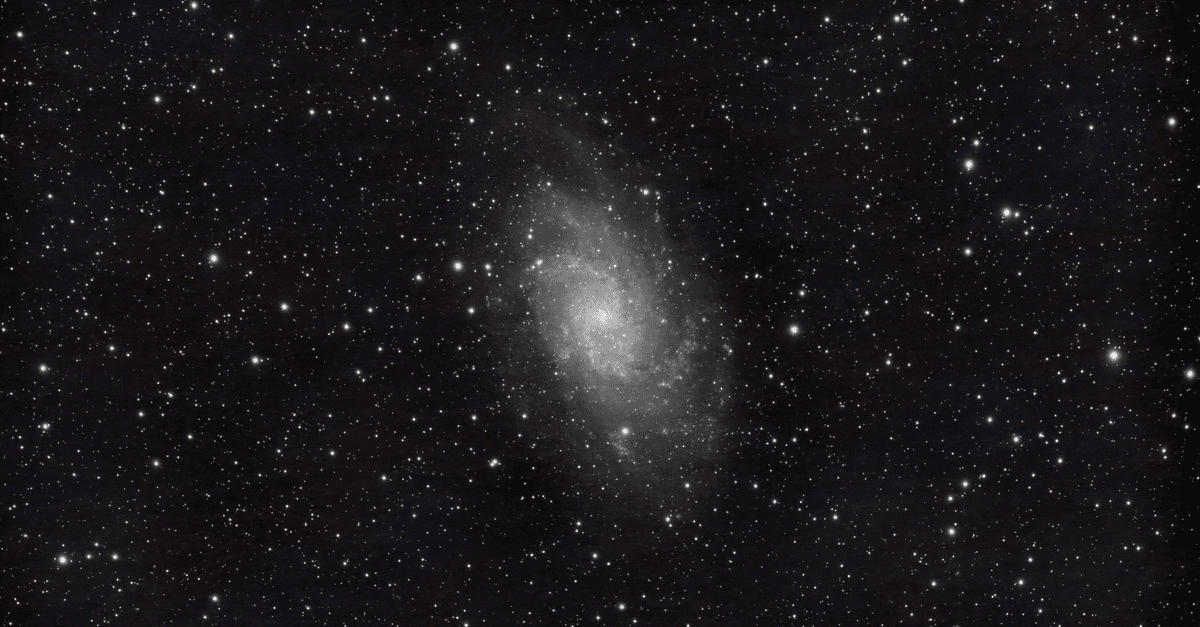 A mesmerizing image of a spiral galaxy surrounded by countless stars in the night sky.