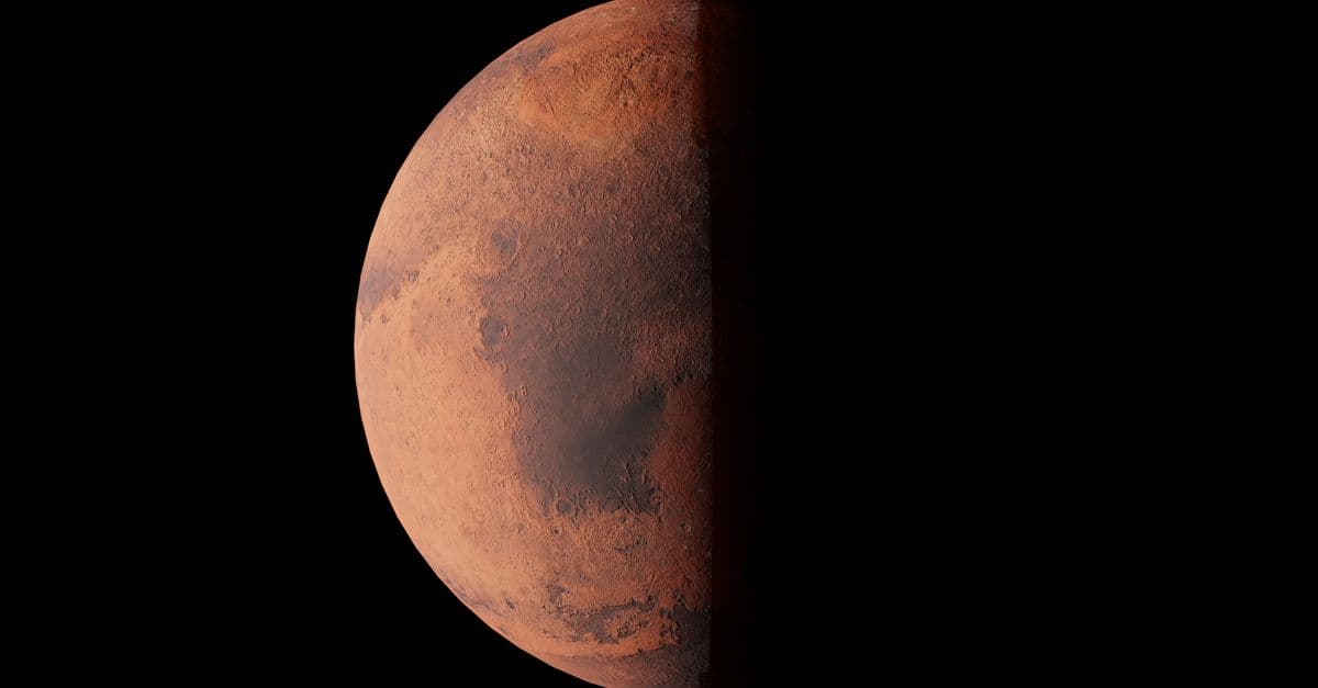 Stunning image of Mars half-illuminated against the blackness of space.