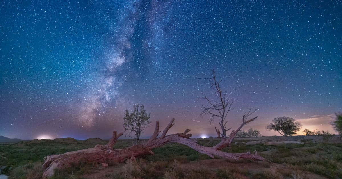 Breathtaking view of the Milky Way lighting up the night sky over a serene desert in Damghan, Iran.
