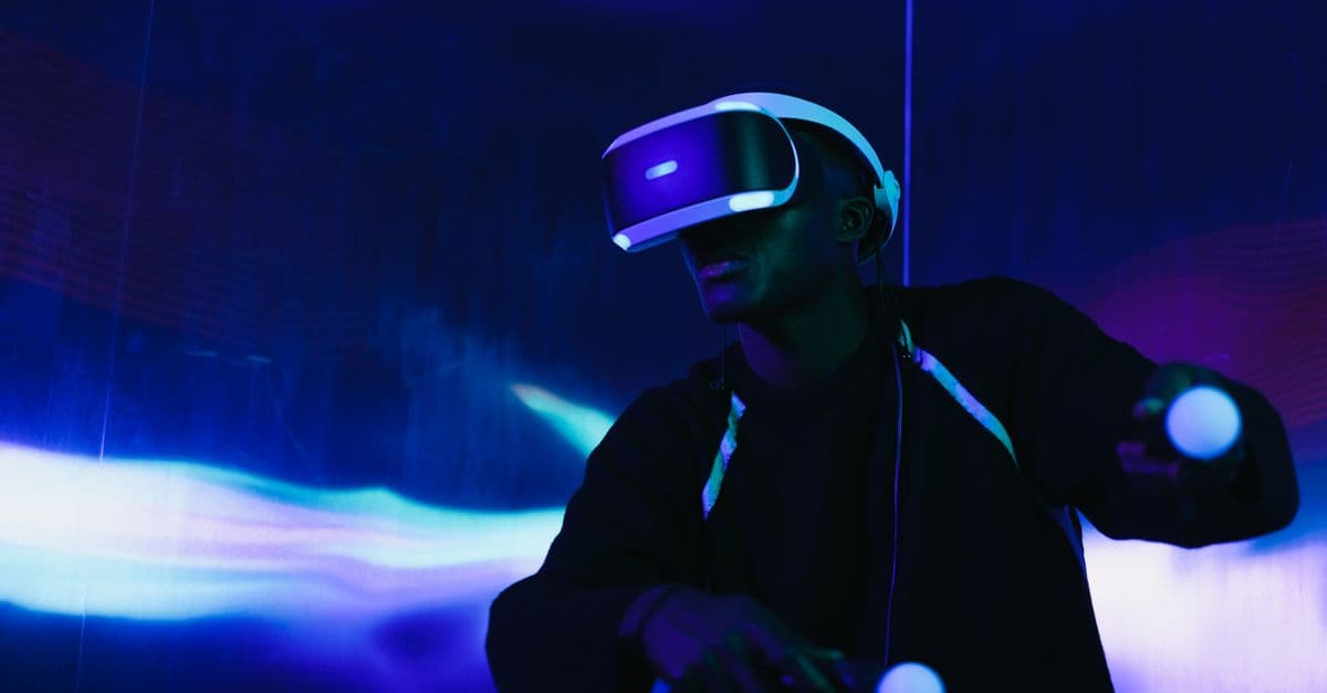 A person engaged in a virtual reality game using a VR headset and motion controllers.