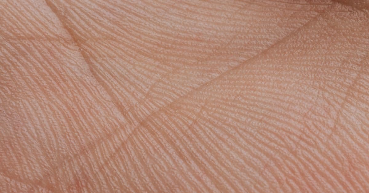 Close-up of people covered in glitter posing artistically with intertwined hands.