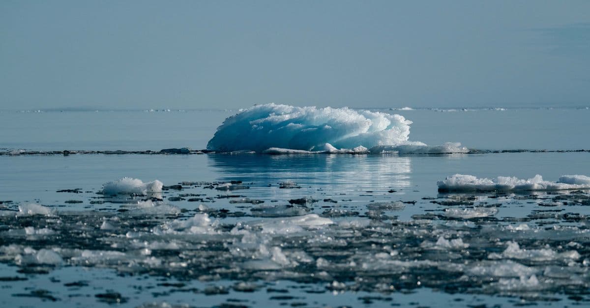 A serene view of a melting iceberg in the Arctic, symbolizing climate change impact.